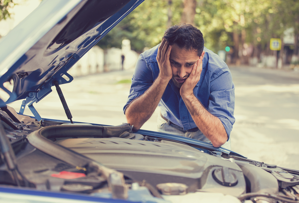 man trying to fix his car