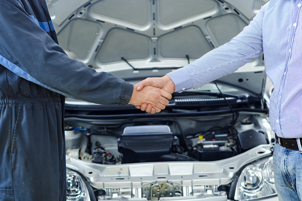 mechanic and customer shaking hands